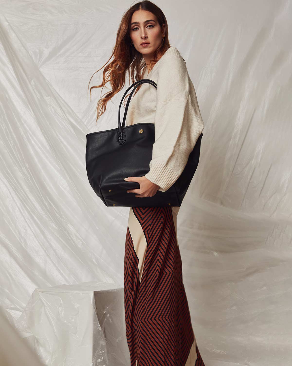 Woman with black plastic recycled shopper bag