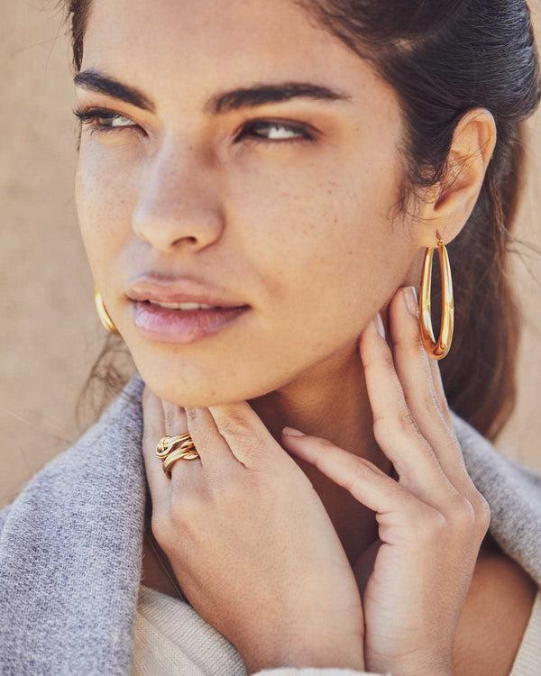 Women's teardrop-shaped earrings combined with rings